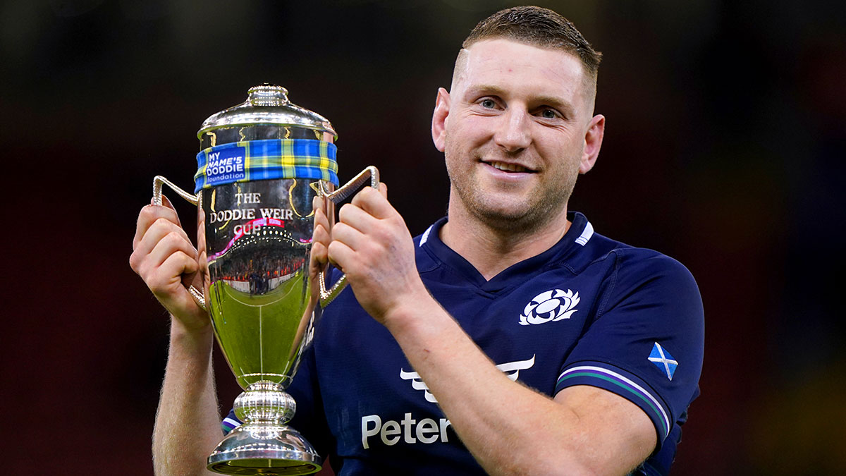 Finn Russell celebrates with the Doddie Weir Cup in 2024 Six Nations 