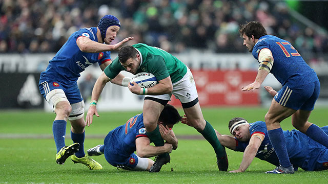 Ireland's Robbie Henshaw grapples with a host of French players