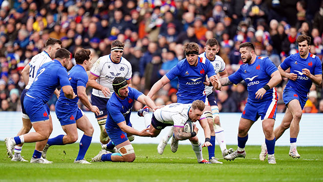 Stuart Hogg is tackled during Scotland v France match in 2022 Six Nations